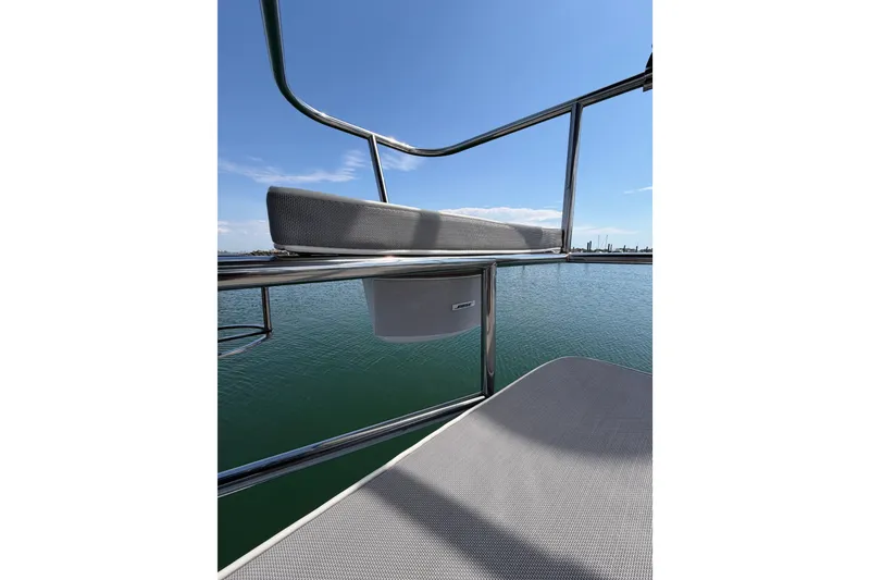 Slide: The Image of 2023 Catalina 425 yacht deck with stainless steel railing, overlooking calm blue water. - 12