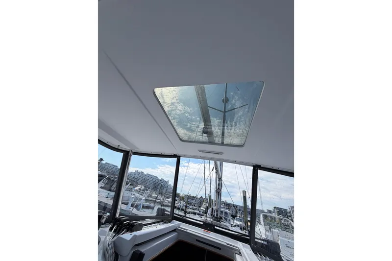 Slide: The Image of Interior view of 2023 Catalina 425 sailboat, showcasing skylight and marina background. - 14