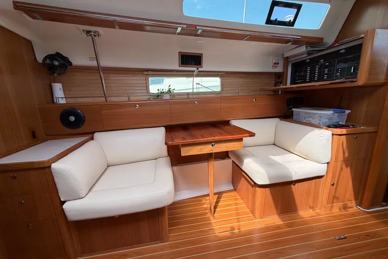 Slide: The Image of Interior of 2023 Catalina 425 yacht with wooden finish and white seating. - 16