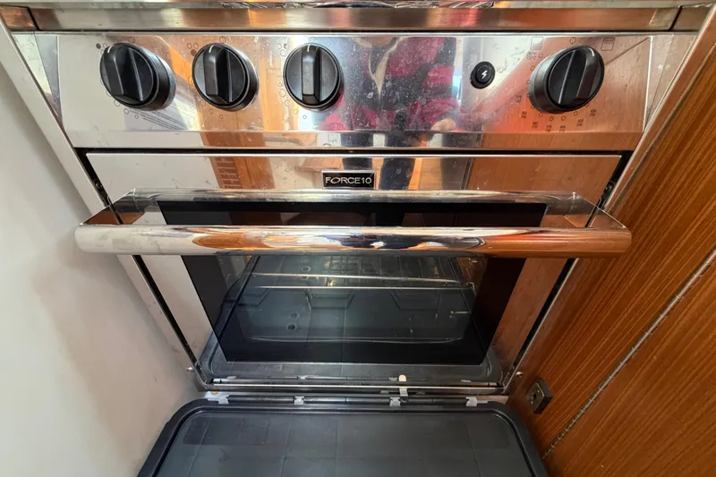 Slide: The Image of Modern Force 10 oven in a 2023 Catalina 425 yacht kitchen, featuring sleek stainless steel design. - 18