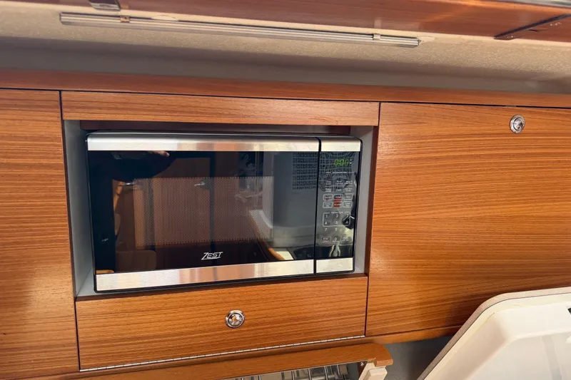 Slide: The Image of Built-in microwave in 2023 Catalina 425 yacht's wooden kitchen cabinetry. - 19