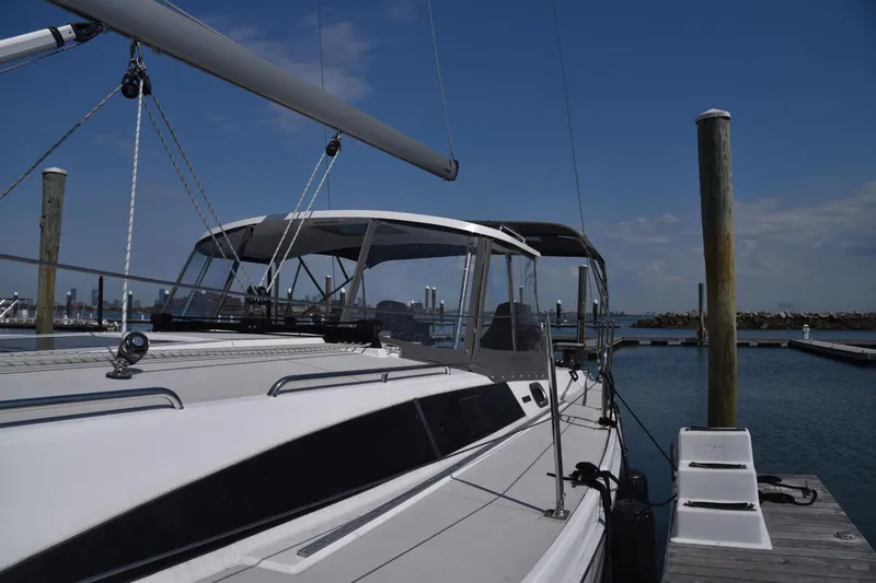 Slide: The Image of 2023 Catalina 425 sailboat docked at marina under clear blue sky. - 2