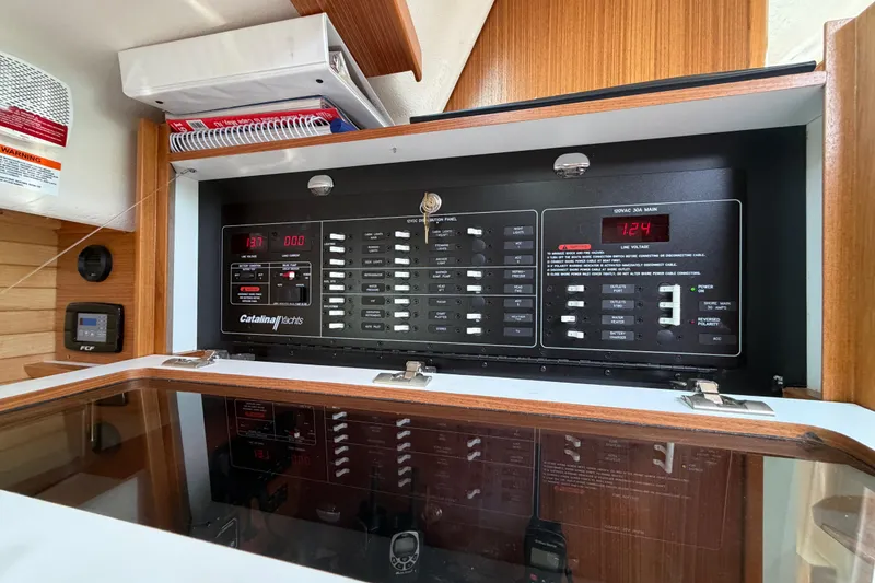 Slide: The Image of Electrical control panel inside 2023 Catalina 425 yacht, featuring switches and voltage display. - 23