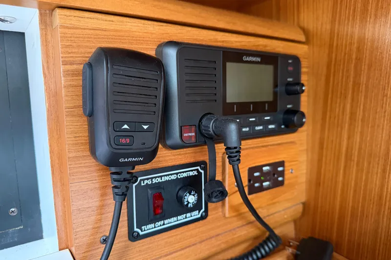 Slide: The Image of Garmin marine radio and controls on 2023 Catalina 425 yacht's wooden panel. - 24
