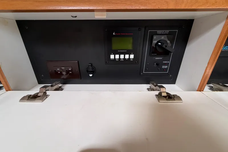 Slide: The Image of Electrical control panel inside 2023 Catalina 425 yacht, featuring switches and outlets. - 28