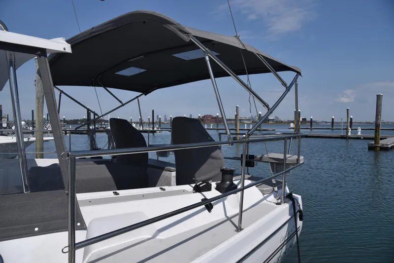 Slide: The Image of 2023 Catalina 425 sailboat docked at marina, featuring shaded cockpit and clear blue sky. - 3