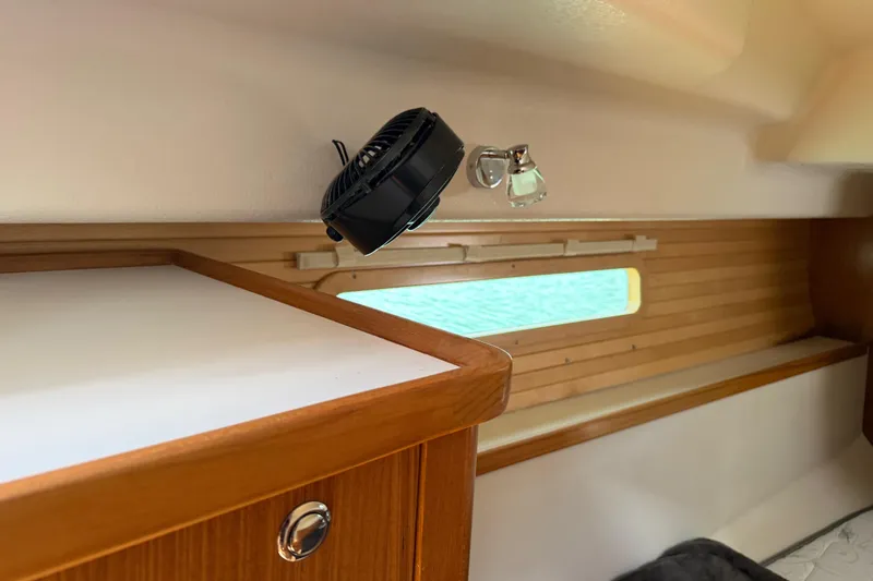 Slide: The Image of Interior of 2023 Catalina 425 yacht with wooden cabinetry and small fan. - 32