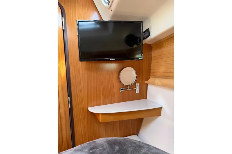 Slide: The Image of 2023 Catalina 425 yacht interior with mounted TV and wooden cabinetry. - 35