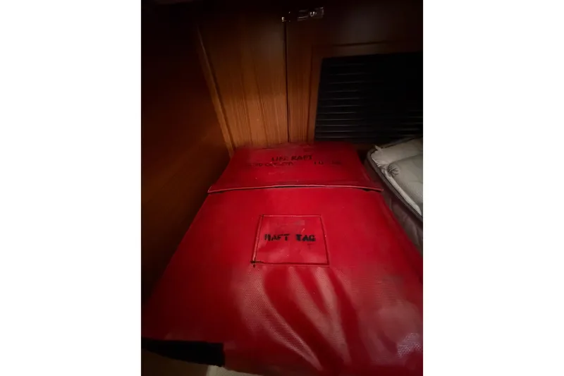 Slide: The Image of Red life raft bag inside 2023 Catalina 425 yacht cabin storage area. - 41