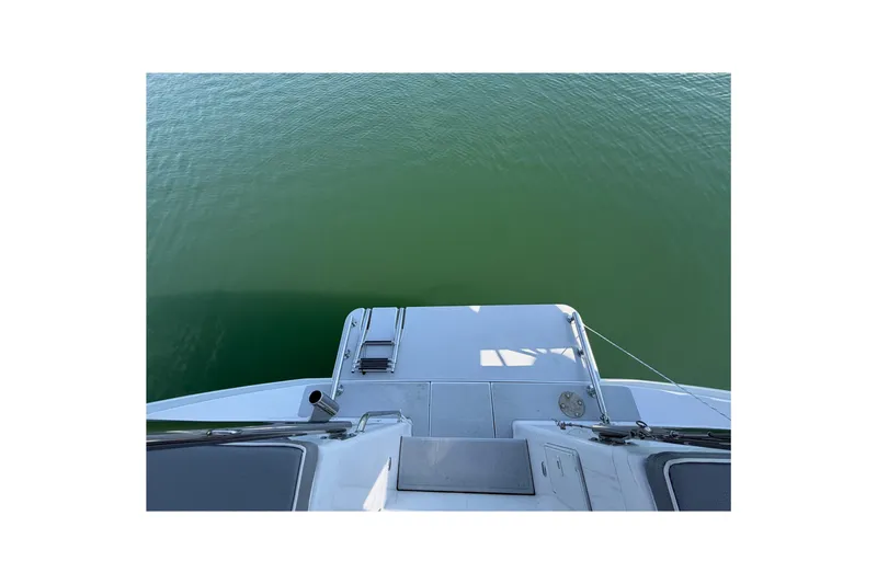 Slide: The Image of View from the deck of a 2023 Catalina 425 sailboat over calm green water. - 6