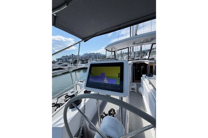 Slide: The Image of Cockpit view of 2023 Catalina 425 sailboat with navigation display and marina backdrop. - 7