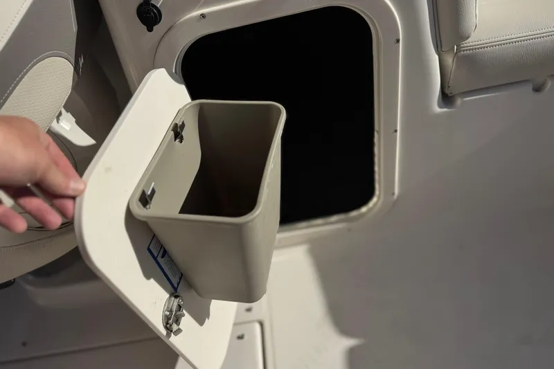 Slide: The Image of 2005 Chaparral 255 SSi boat storage compartment with removable bin. - 14