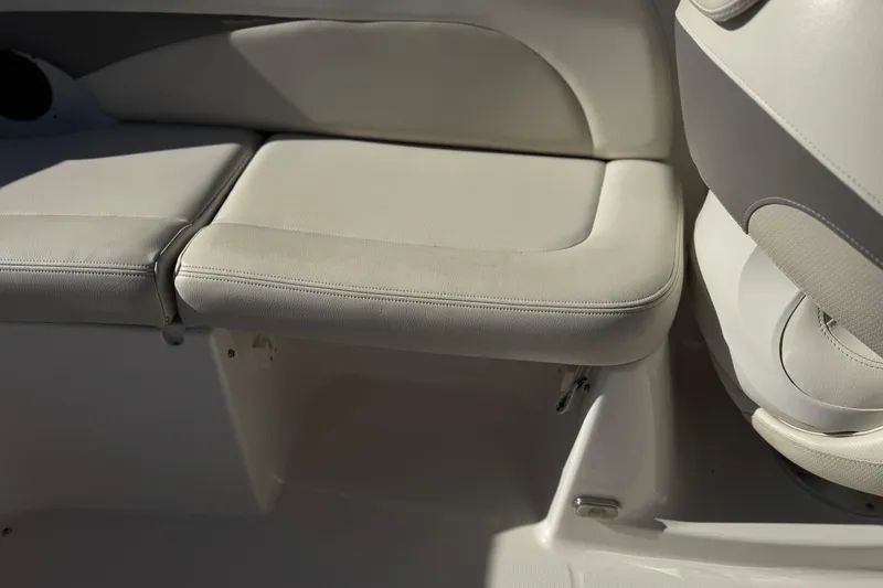 Slide: The Image of 2005 Chaparral 255 SSi boat interior seating, featuring light beige upholstery. - 16