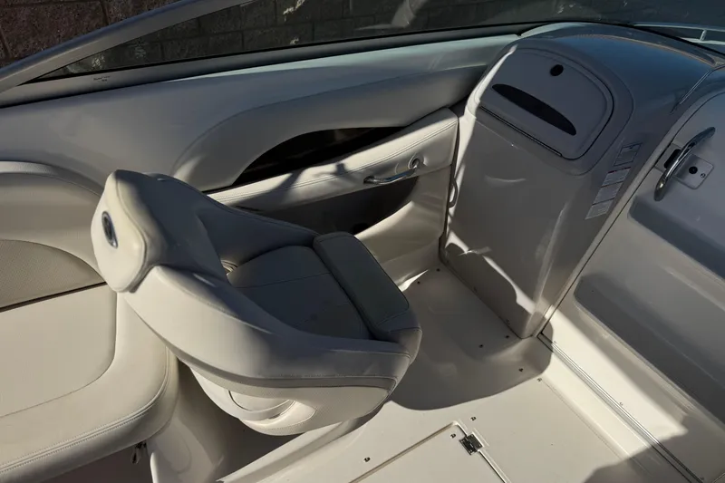 Slide: The Image of Interior of a 2005 Chaparral 255 SSi boat, featuring a sleek white seat design. - 19