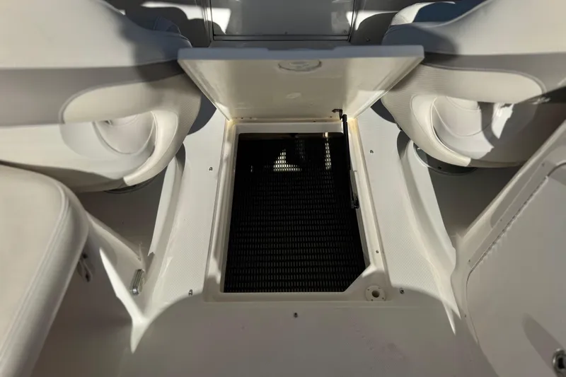Slide: The Image of 2005 Chaparral 255 SSi boat interior storage compartment with open hatch. - 20