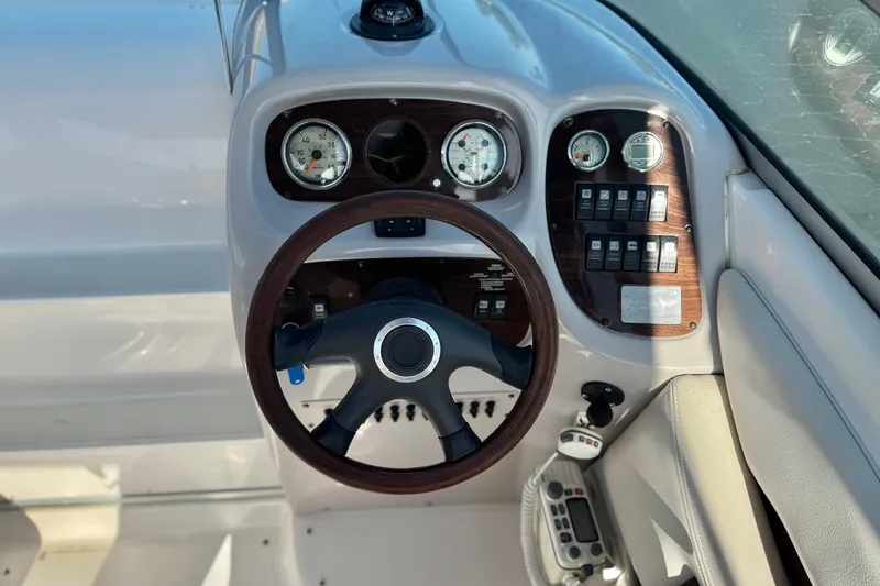 Slide: The Image of 2005 Chaparral 255 SSi boat dashboard with steering wheel and control gauges. - 22