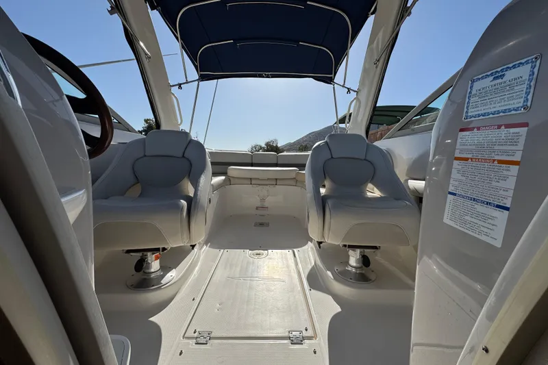 Slide: The Image of Interior view of a 2005 Chaparral 255 SSi boat with seating and canopy. - 23