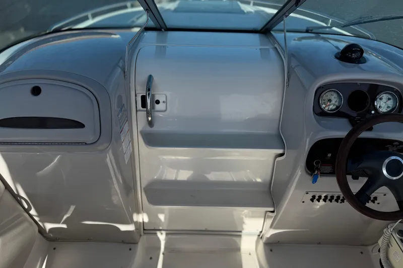 Slide: The Image of 2005 Chaparral 255 SSi boat dashboard with steering wheel and gauges. - 24