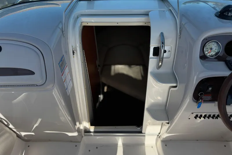 Slide: The Image of 2005 Chaparral 255 SSi boat cabin entrance with dashboard and controls. - 25