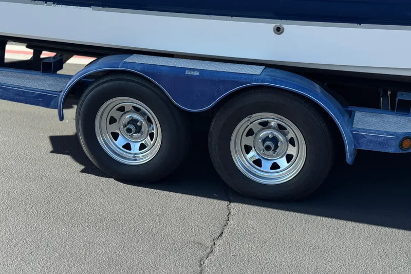 Slide: The Image of Trailer wheels of a 2005 Chaparral 255 SSi boat on pavement. - 31