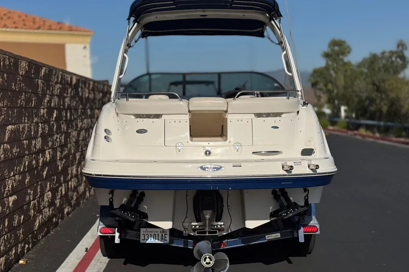 Slide: The Image of 2005 Chaparral 255 SSi boat parked on a street, rear view. - 4