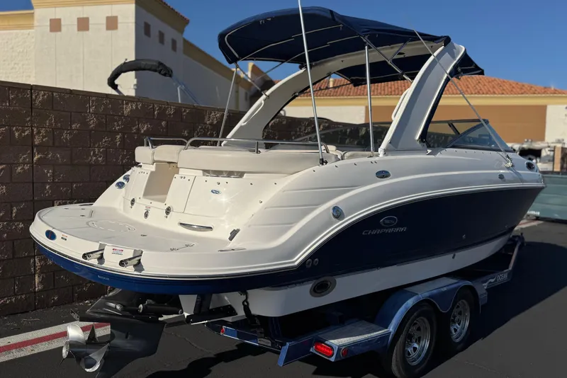 Slide: The Image of 2005 Chaparral 255 SSi boat on trailer, parked outdoors with blue canopy. - 5
