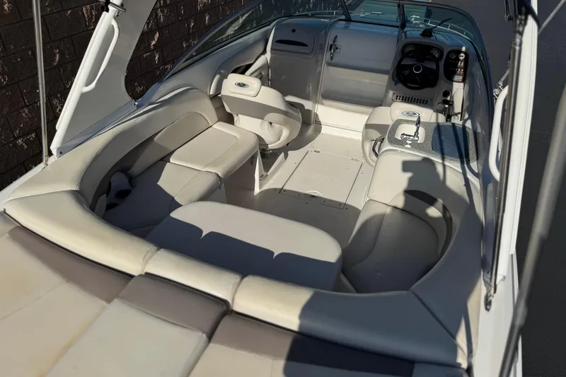 Slide: The Image of 2005 Chaparral 255 SSi boat interior with seating and steering console. - 9