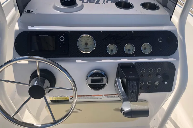 Slide: The Image of Center console of 2022 Key Largo 1800 boat with steering wheel and gauges. - 11