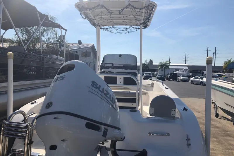 Slide: The Image of 2022 Key Largo 1800 Center Console boat with Suzuki engine in a marina. - 4