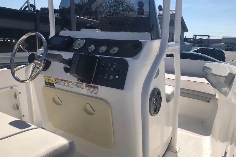 Slide: The Image of 2022 Key Largo 1800 Center Console boat interior with steering wheel and control panel. - 5