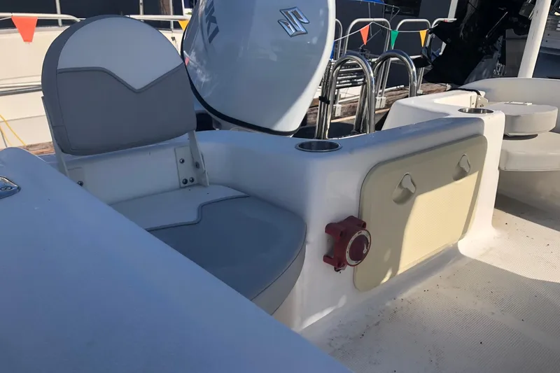 Slide: The Image of 2022 Key Largo 1800 Center Console boat interior with seating and storage compartments. - 7