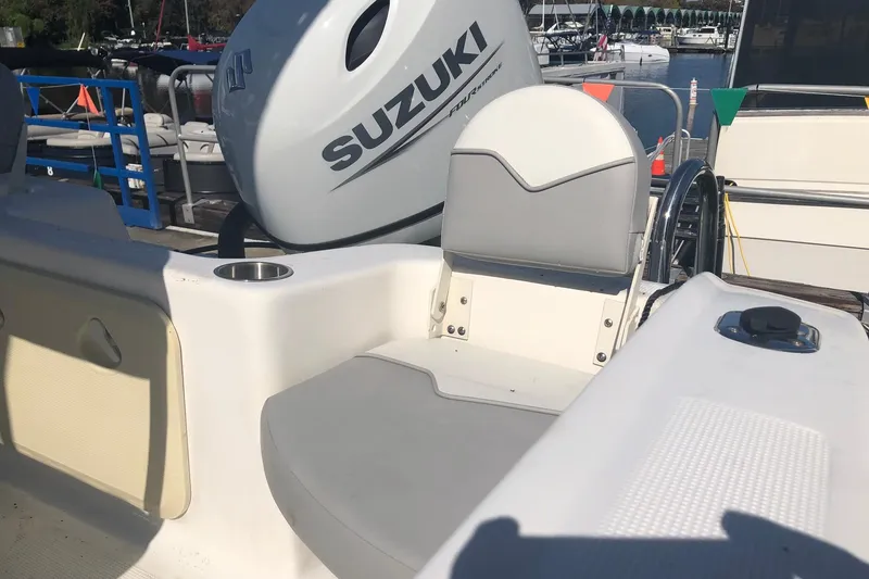 Slide: The Image of 2022 Key Largo 1800 Center Console boat with Suzuki engine at marina. - 8