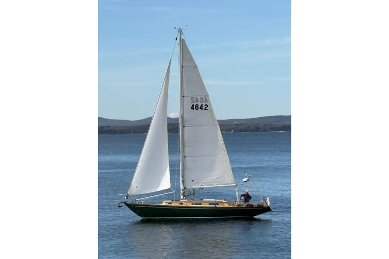 The Image of Sailing yacht Ohlson 38 from 1969 on calm waters with distant hills. - 0
