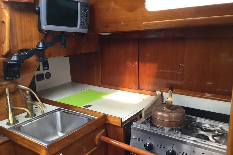 Slide: The Image of 1969 Ohlson 38 yacht bathroom with wooden cabinetry and marine toilet. - 10