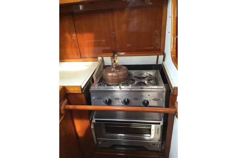 Slide: The Image of Wooden interior of a 1969 Ohlson 38 sailboat with a compact sink area. - 11