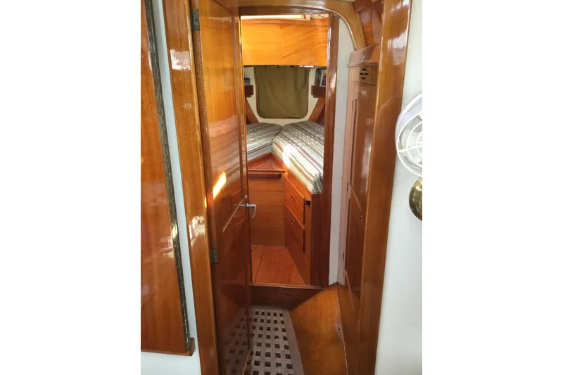 Slide: The Image of Interior of a 1969 Ohlson 38 sailboat with wooden cabinetry and navigation equipment. - 12