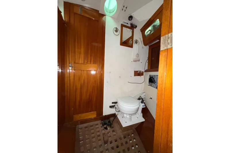 Slide: The Image of 1969 Ohlson 38 yacht bathroom with wooden cabinetry and marine toilet. - 7