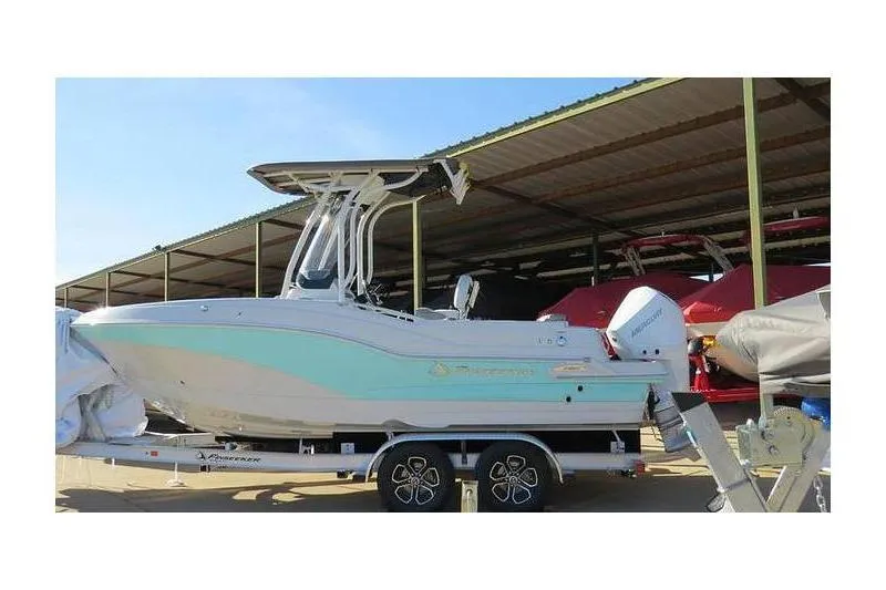 The Image of 2024 Finseeker 210 CC boat on trailer under a covered storage area. - 1