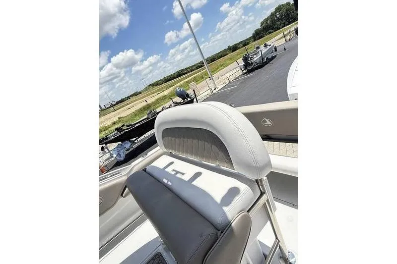 Slide: The Image of 2024 Finseeker 210 CC boat seat with scenic outdoor background. - 12