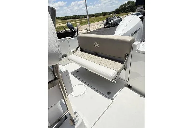 Slide: The Image of 2024 Finseeker 210 CC boat with cushioned seating and Mercury engine in a sunny outdoor setting. - 14