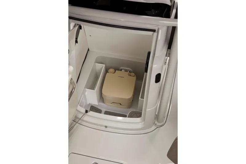 Slide: The Image of 2024 Finseeker 210 CC boat interior with storage compartment and portable toilet. - 17