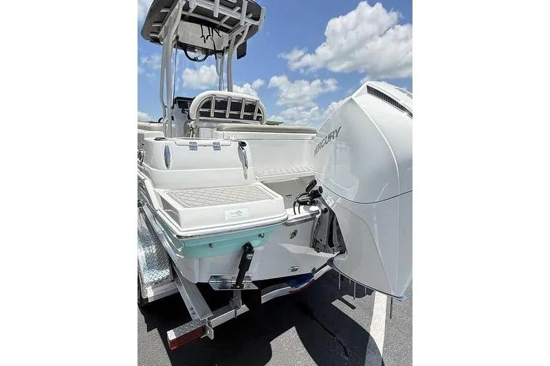 Slide: The Image of 2024 Finseeker 210 CC boat with Mercury engine, rear view under sunny sky. - 4