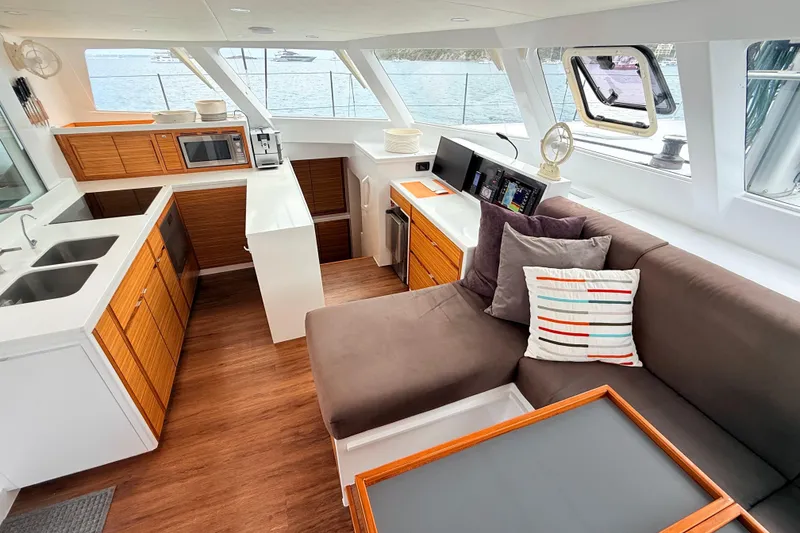 Slide: The Image of Modern yacht interior with kitchen and lounge area, featuring wood accents and ocean view. Balance 526, 2021. - 11