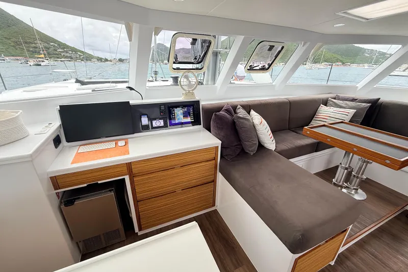 Slide: The Image of Modern yacht interior with navigation station, plush seating, and scenic ocean view. Balance 526, 2021 model. - 12
