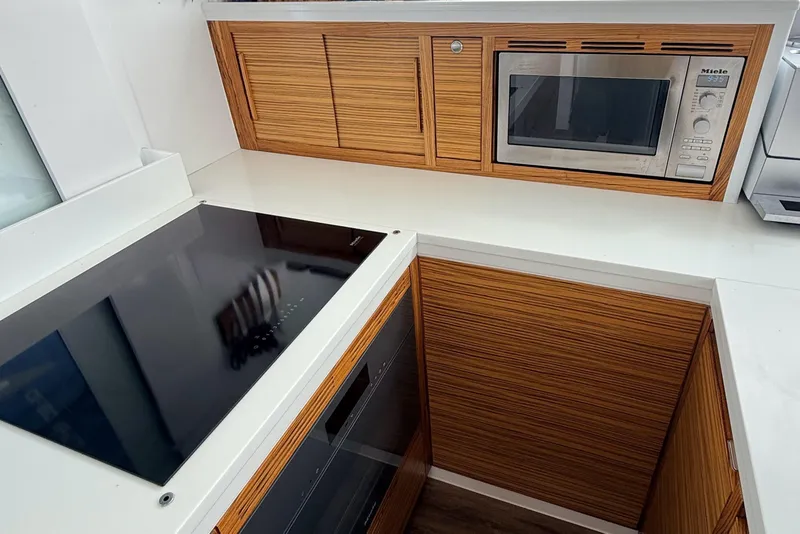 Slide: The Image of Modern kitchen with wooden cabinets, induction cooktop, and built-in microwave, Balance 526 model, 2021. - 13