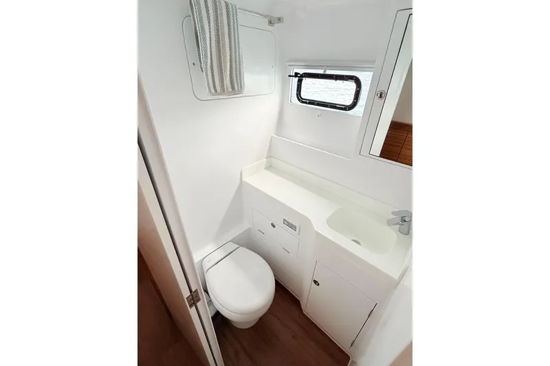 Slide: The Image of Compact bathroom in 2021 Balance 526 yacht with toilet, sink, and window. - 24