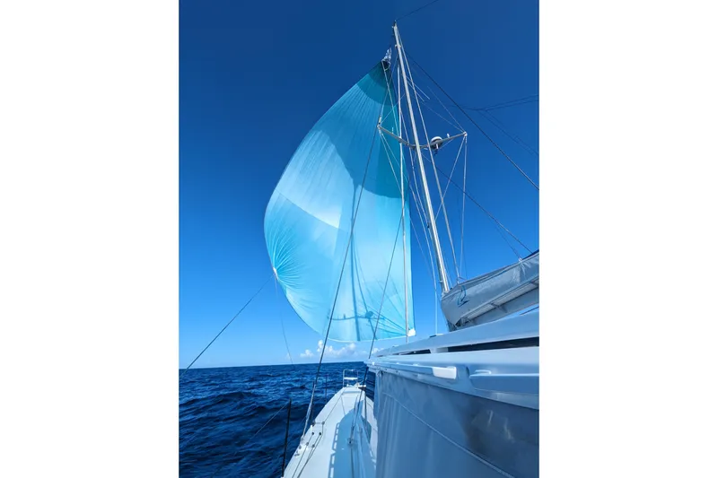 Slide: The Image of Sailing yacht Balance 526 with blue spinnaker against clear sky, 2021 model. - 3