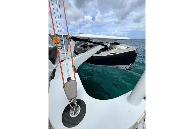Slide: The Image of Sailboat Balance 526 (2021) with dinghy on deck, sailing in clear blue waters. - 42