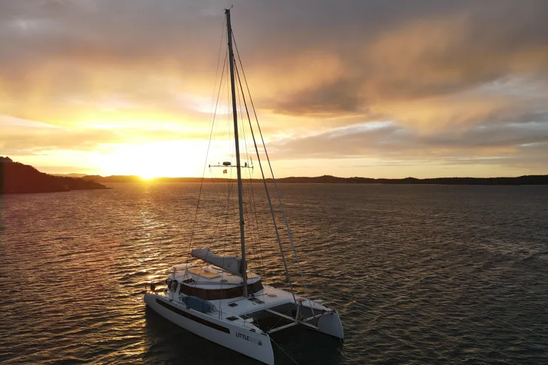 Slide: The Image of Sailing catamaran Balance 526 at sunset on the ocean, 2021 model. - 47