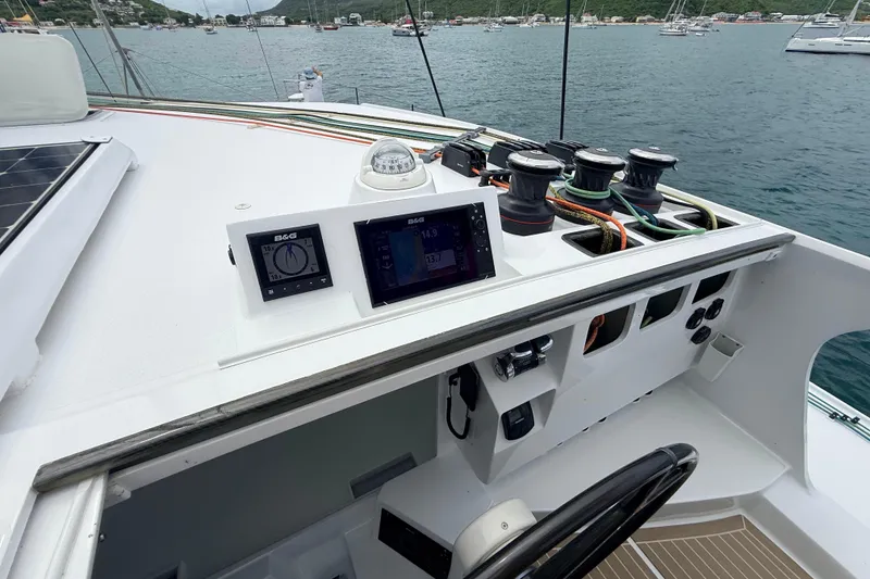Slide: The Image of Sailing yacht Balance 526 cockpit with navigation instruments, winches, and scenic harbor view. - 5